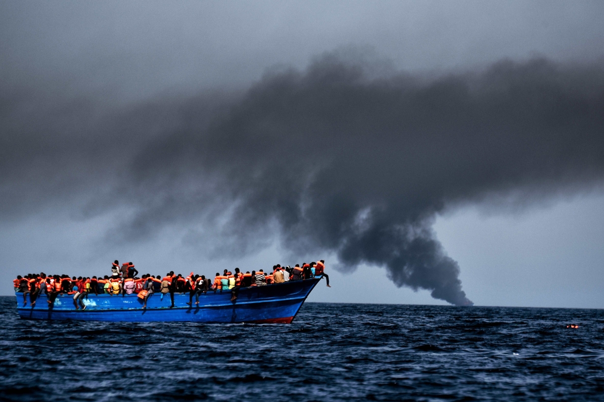 Migrants wait to be rescued as they drift at sunset in the Mediterranean Sea some 20 nautical miles north off the coast of Libya on October 3, 2016. (Getty)