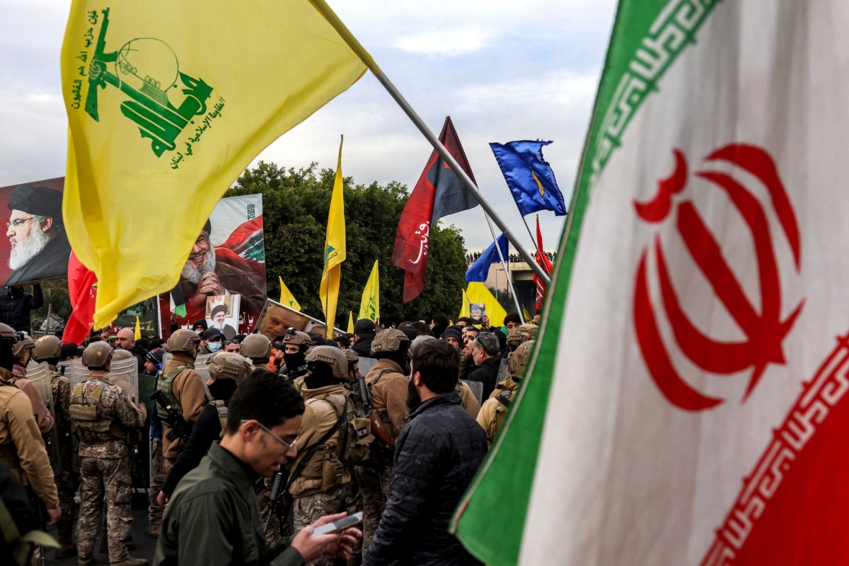 Protesters wave Iranian and Hezbollah flags during a rally at Beirut airport on February 15, 2025. Iran's strategy of using militias is now in tatters.
