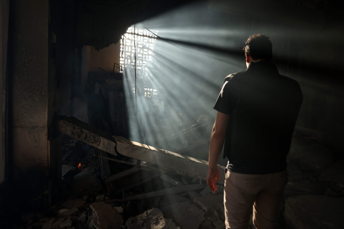 A man checks the destruction inside the heavily damaged Syrian army and defence ministry headquarters complex in Damascus, following Israeli strikes on July 16, 2025.