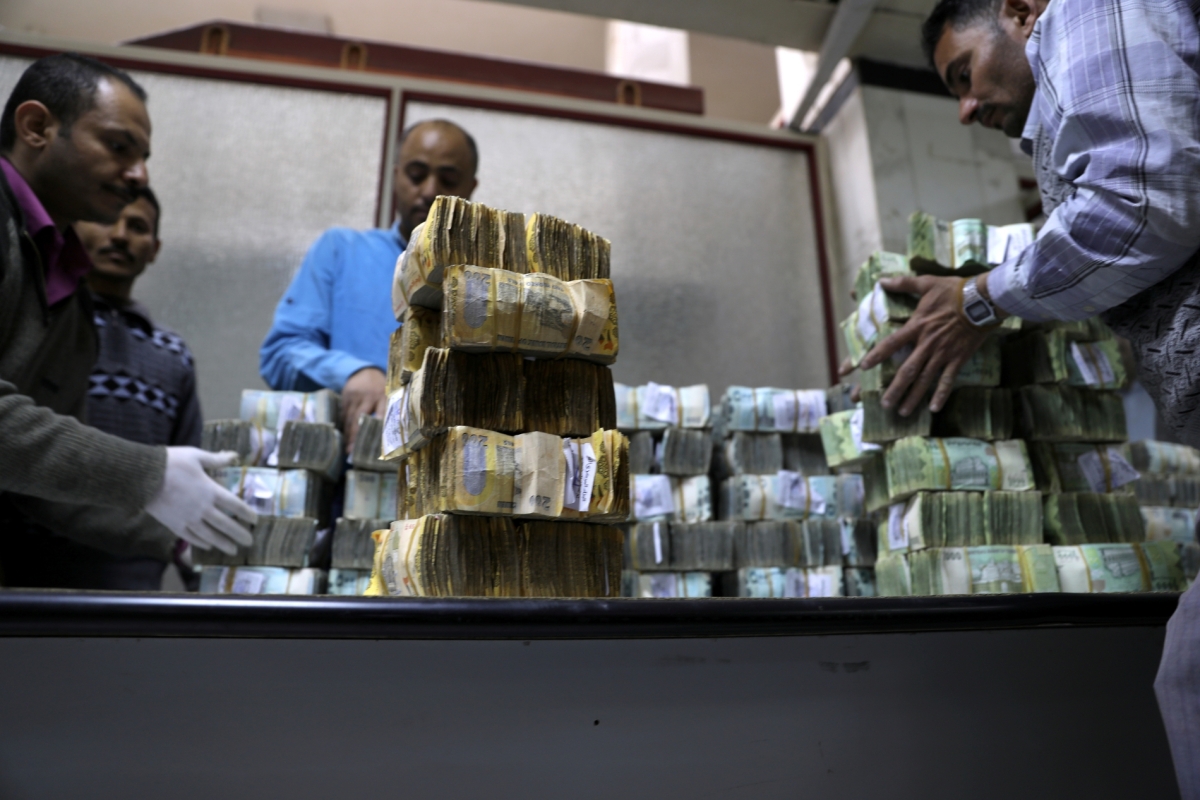 Employees count bundles of Yemeni Riyal banknotes at the Central Bank of Yemen in Sanaa on January 7, 2020.