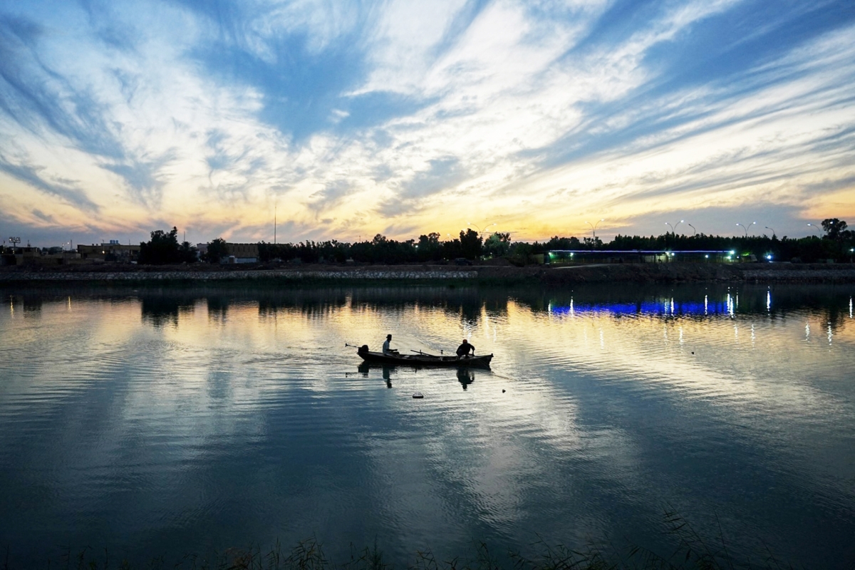 An Iraqi fisherman casts his net in the Euphrates River, which passes through the city of Nasiriyah the capital of the Iraqi Dhi Qar Governorate on January 2, 2024. 