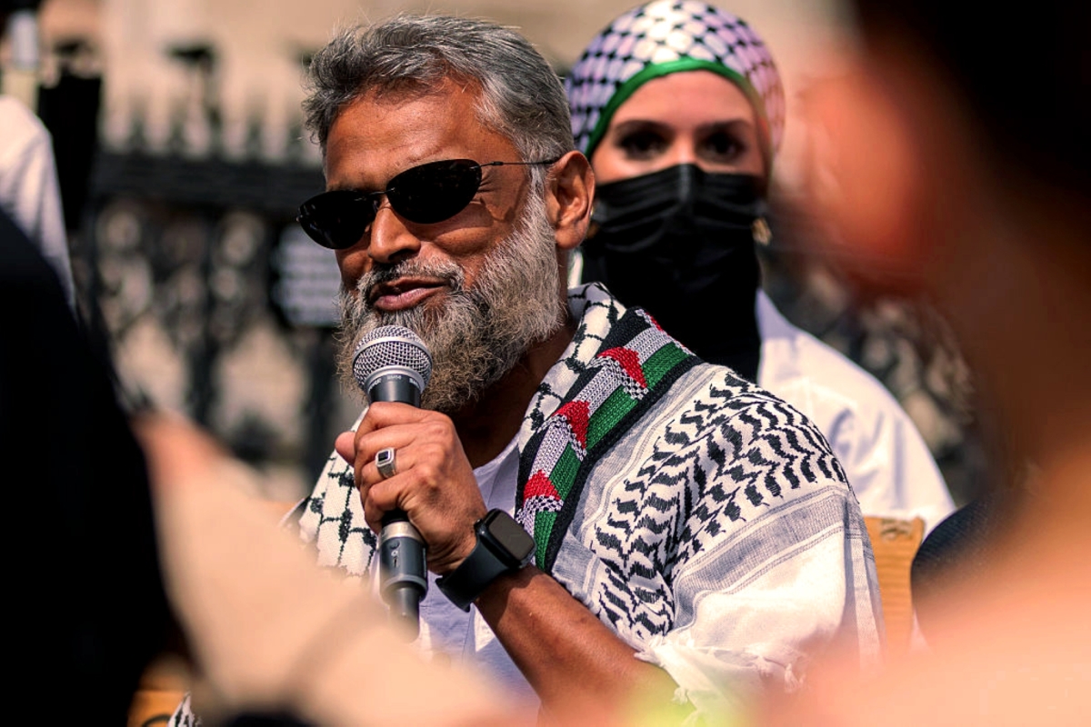 Moazzam Begg, Senior Director at CAGE International, addresses pro-Palestinian activists gathered outside the Royal Courts of Justice on July 4, 2025, in London.
