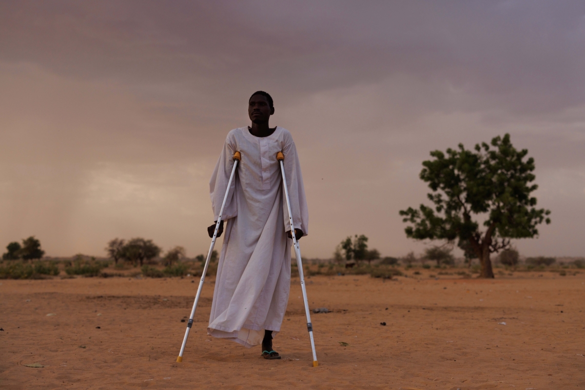 Ishag Abdullah Khatir, 30, from Geneina in West Sudan, whose leg was amputated after RSF soldiers shot him, poses for a portrait on April 20, 2024, in Adre, Chad. 