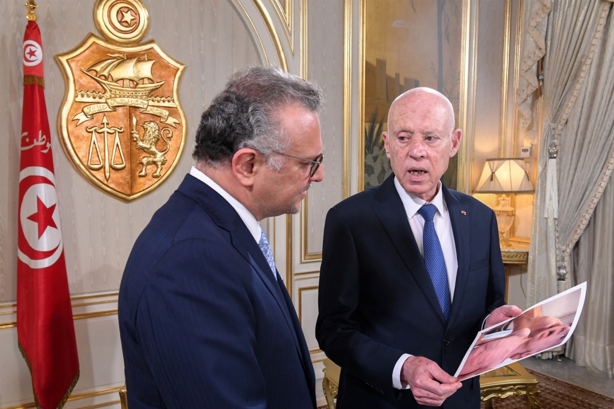 Tunisia's President Kais Saied (R) shows Massad Boulos, senior adviser to the US president for Africa, pictures of starving children in Gaza during their meeting at the presidential palace in Carthage on July 22, 2025.