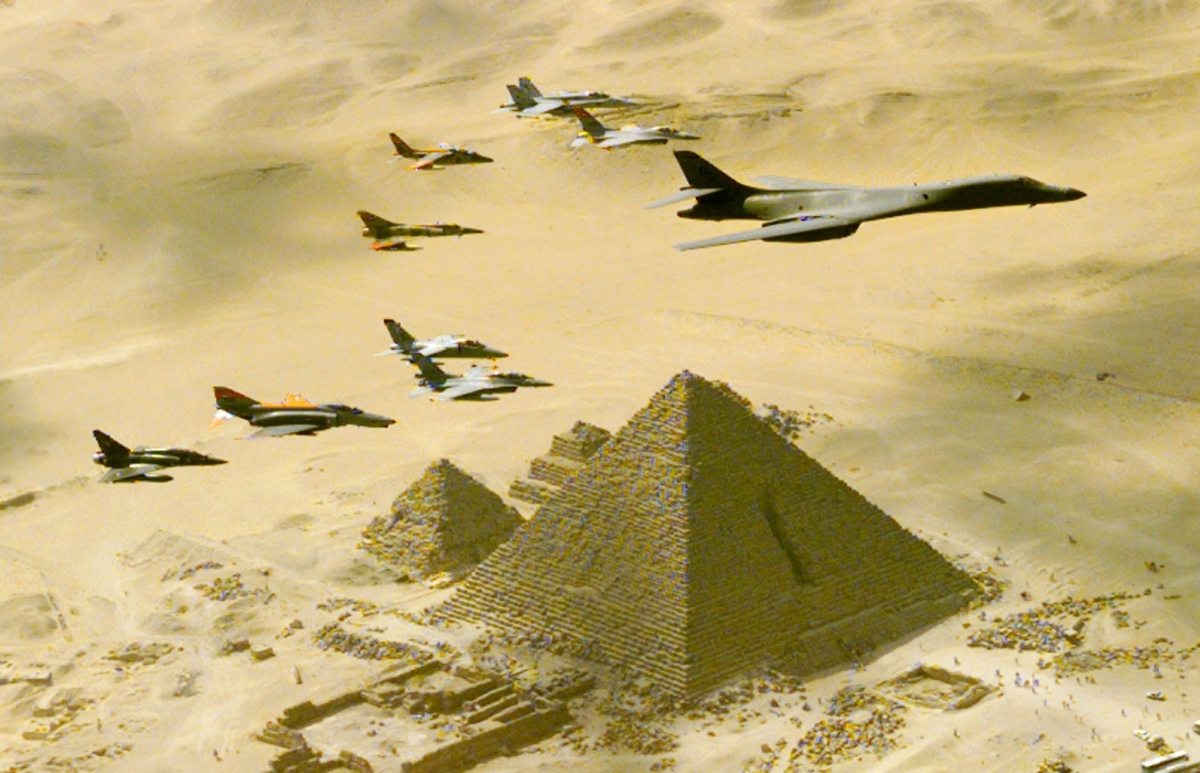 A US Air Force B-1B bomber is followed by fighter planes above one of the three Great Pyramids of Giza, Egypt, on October 25, during a demonstration flight as part of the Bright Star 99 military exercises. 