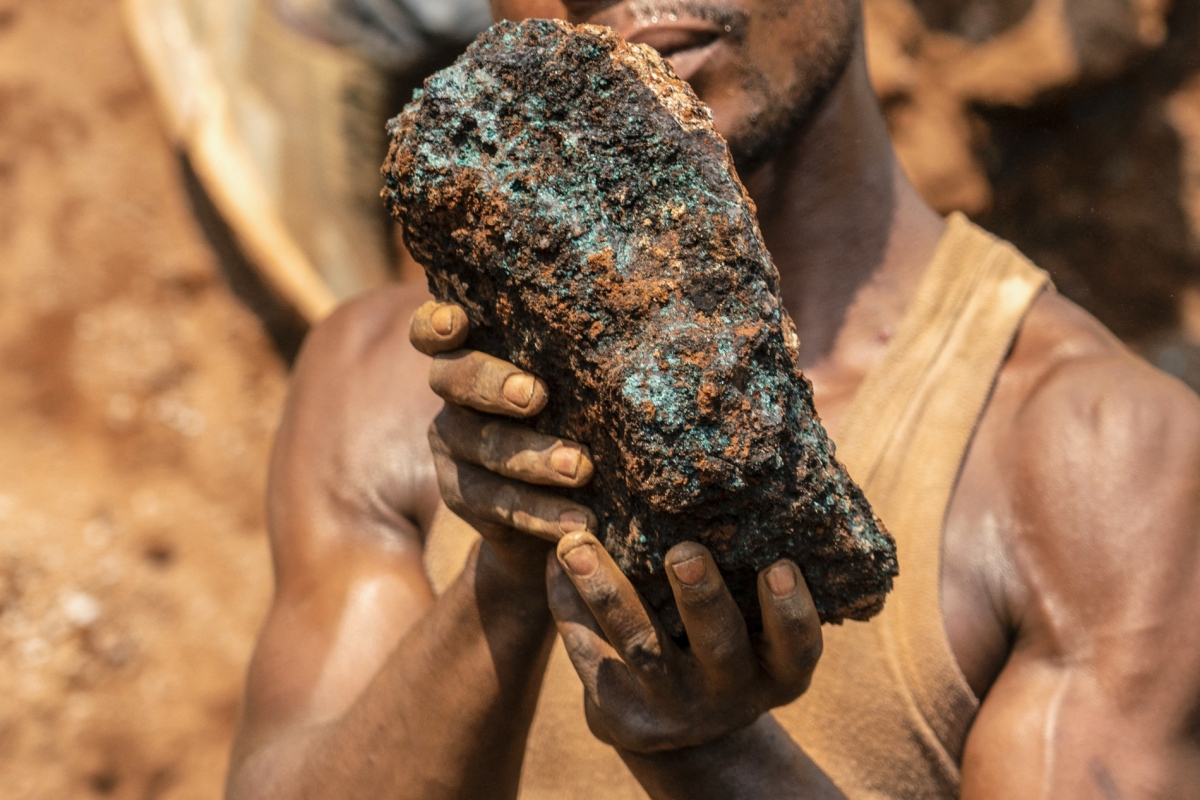 Dela wa Monga, an artisanal miner, holds a cobalt stone at the Shabara artisanal mine near Kolwezi in the Democratic Republic of Congo on October 12, 2022. 