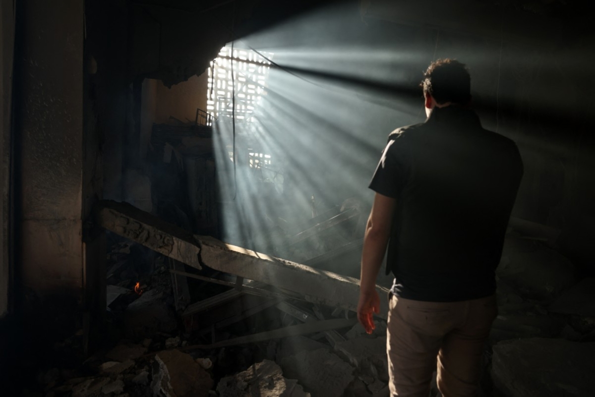 A man checks the destruction inside the heavily damaged Syrian army and defence ministry headquarters complex in Damascus, following Israeli strikes on July 16, 2025.