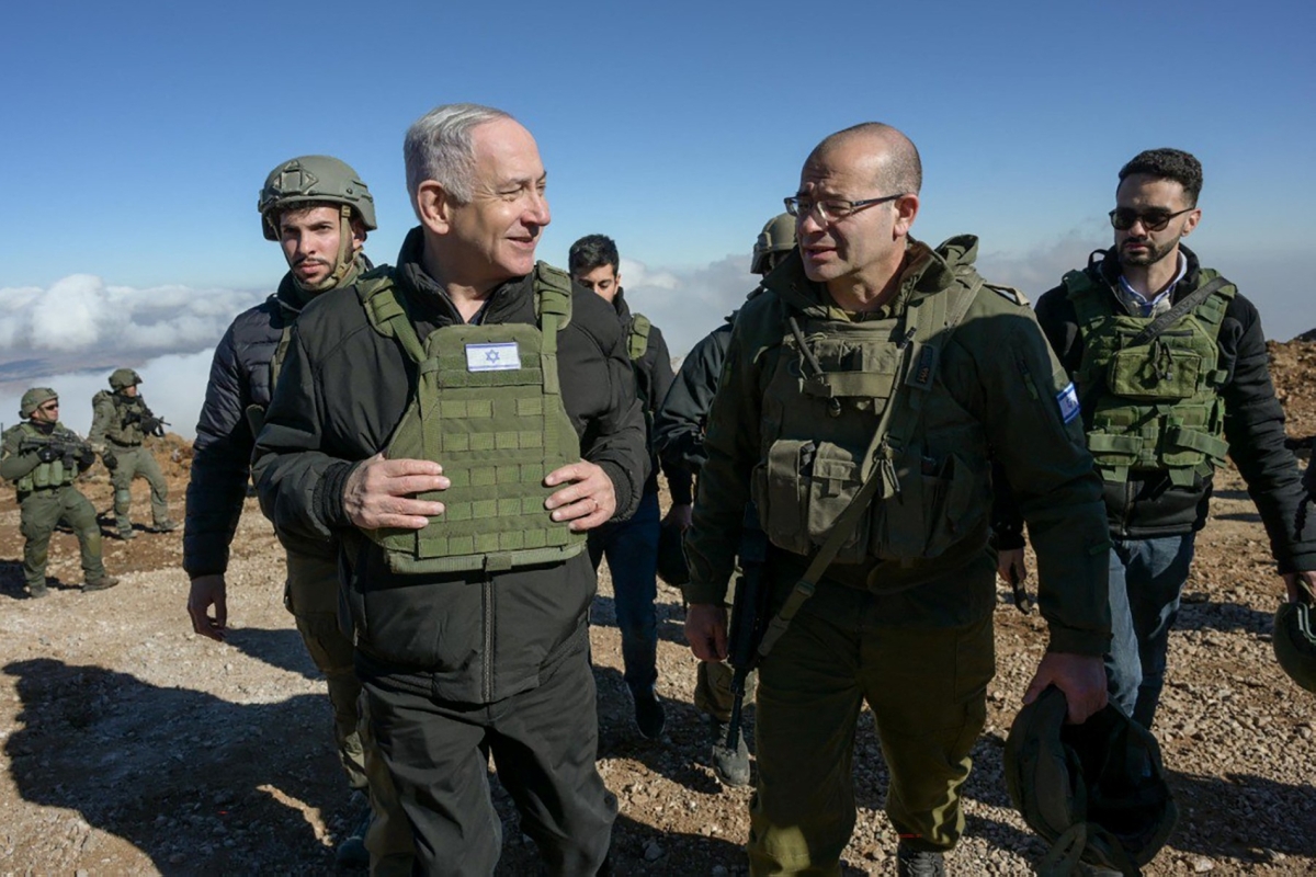 Israeli Prime Minister Benjamin Netanyahu (L) walks among members of the Israeli army at Mount Hermon in the Israeli-annexed Golan Heights of Syria, on December 17, 2024.