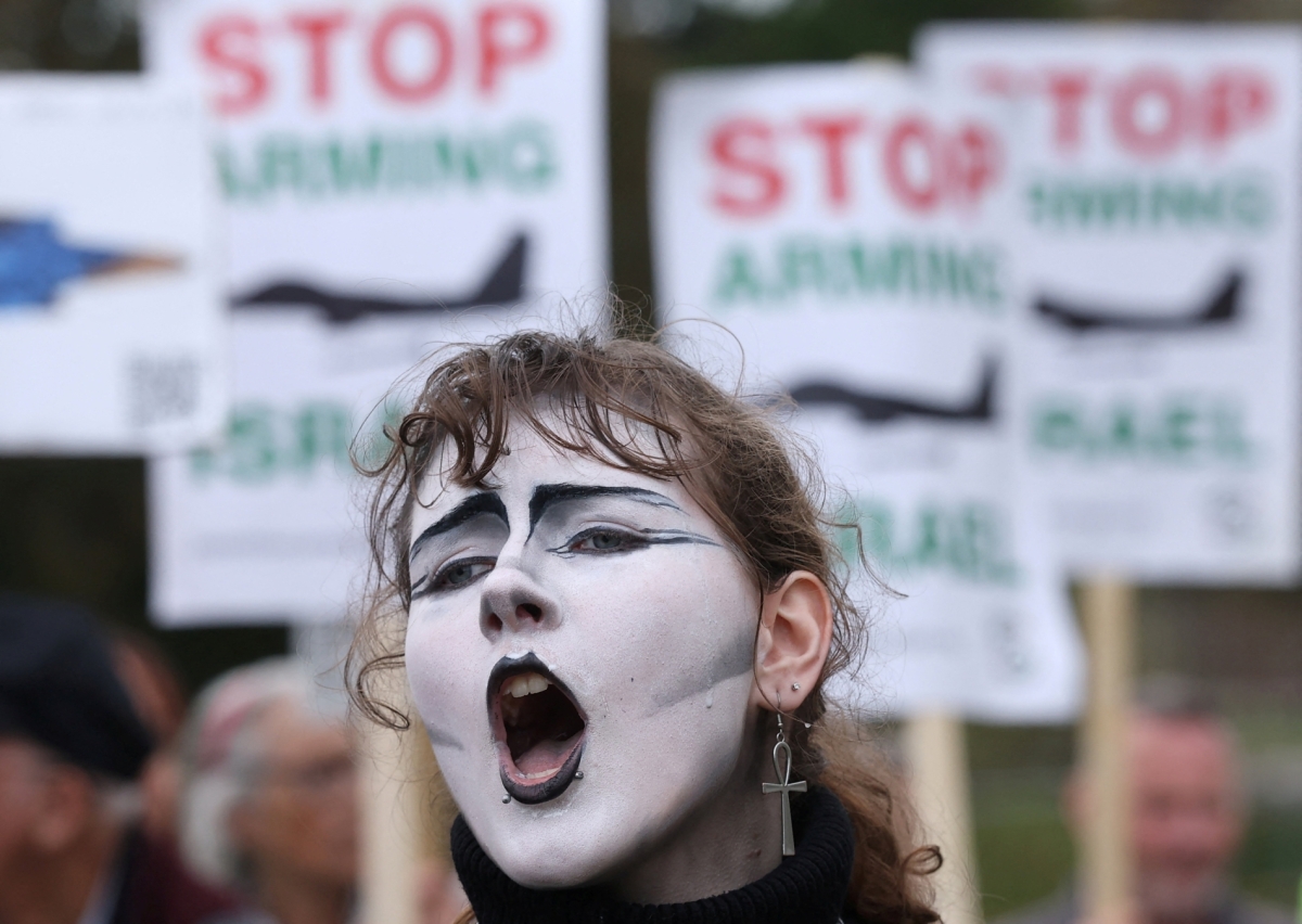A protester highlights British companies’ involvement in manufacturing F-35 fighter jets used in Gaza, demanding an arms embargo on Israel, outside the offices of Lockheed Martin, in Havant, Britain, October 8, 2025. 