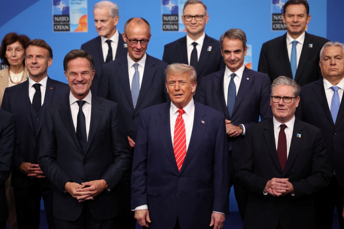 US President Donald Trump stands next to NATO Secretary General Mark Rutte and British Prime Minister Keir Starmer as NATO leaders pose for a group photo at a NATO summit in The Hague, Netherlands, on June 25, 2025.