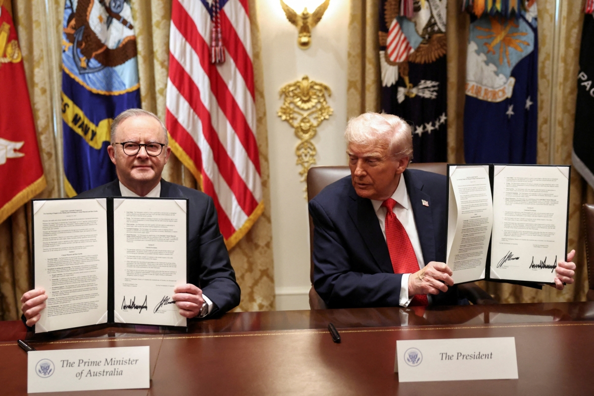 US President Donald Trump and Australia's Prime Minister Anthony Albanese hold a signed agreement on rare earths and critical minerals during a meeting in the Cabinet Room at the White House in Washington, DC, on October 20, 2025. 