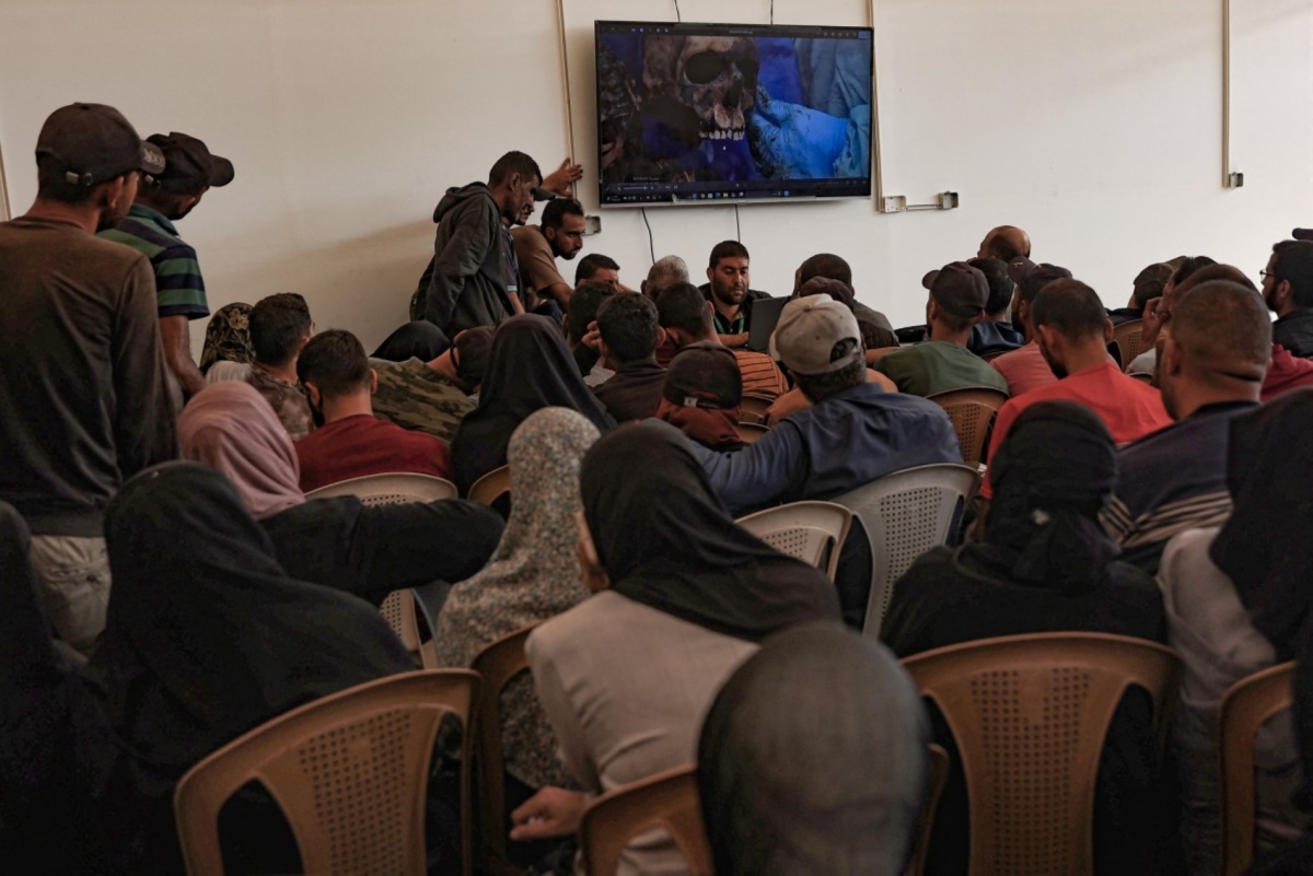 Details of the remains of Palestinians released by Israel are shown on a screen in order to help family members to identify their relatives, at the Nasser hospital in Khan Yunis in the southern Gaza Strip on 18 October 2025.