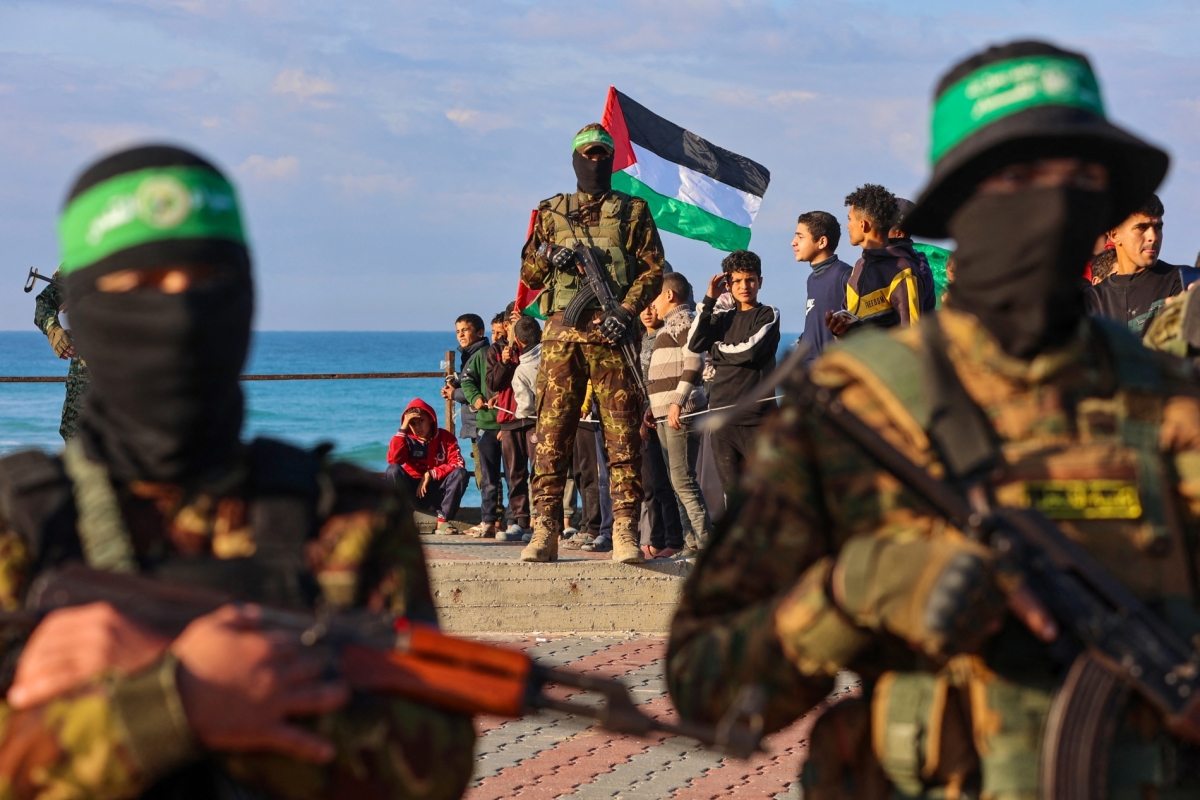 Hamas fighters secure an area before handing over an Israeli-American hostage to a Red Cross team in Gaza City on February 1, 2025, as part of the fourth hostage-prisoner exchange. 