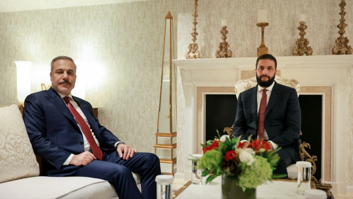 Syria's President Ahmed al-Sharaa (R) meets with the Turkish Foreign Minister Hakan Fidan, on the sidelines of their official visit to Washington DC on 11 November 2025.