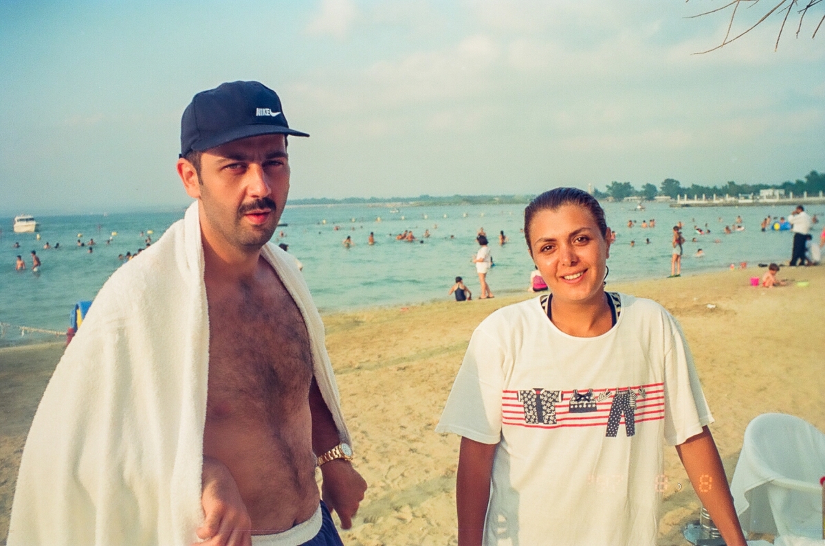 Maher al-Assad with his wife Manal al-Jadaan on the beach.