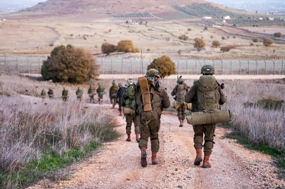 Israeli Paratroopers' Brigade members operate in a location given as the
Syrian border, in this handout picture
released on 13 December 2024.