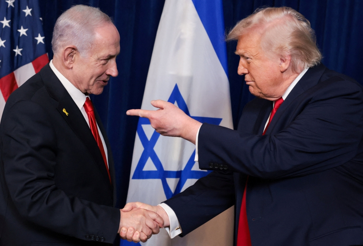 US President Donald Trump points his finger towards Israeli Prime Minister Benjamin Netanyahu as they shake hands during a press conference after meeting at Trump’s Mar-a-Lago club in Palm Beach, Florida, on 29 December 2025.