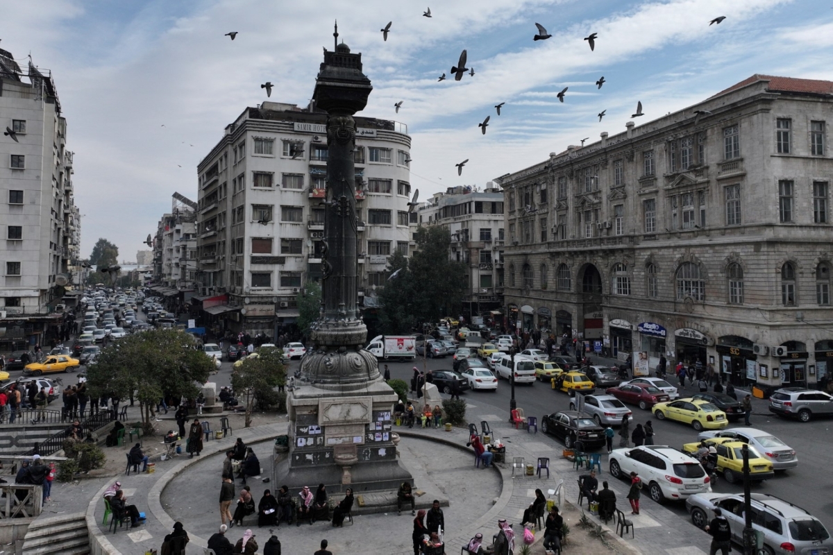An aerial view shows pigeons flying over the Marjeh square in Syria's capital Damascus on 12 December 2024.