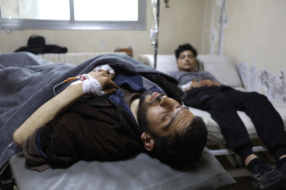 Men recover at the Karm al-Louz Hospital following an explosion at the Imam Ali ibn Abi Talib Mosque, in Homs, on 26 December 2025.