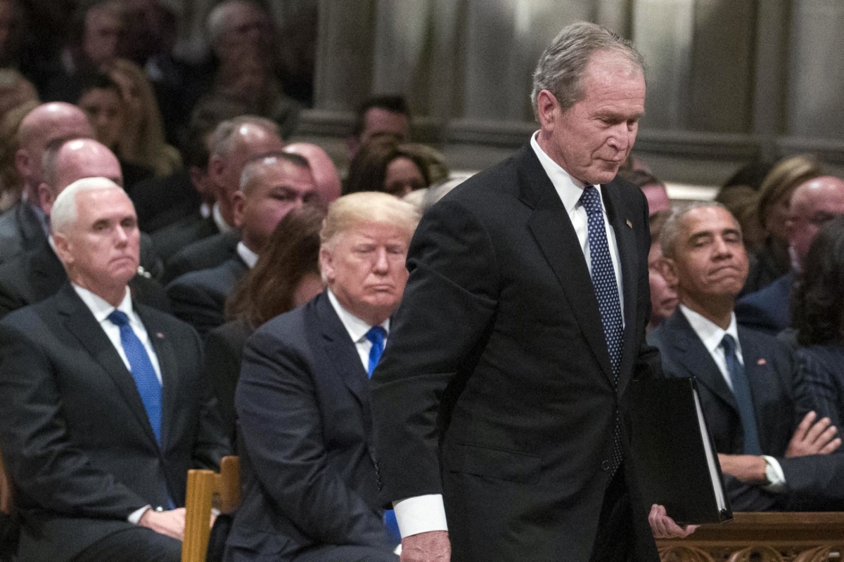 Former President George W. Bush walks past President Donald Trump during the state funeral for President George H.W. Bush, at the National Cathedral, on 5 December 2018, in Washington, DC.