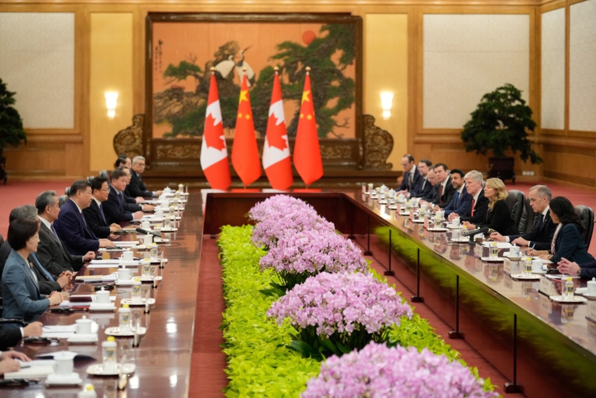 Chinese President Xi Jinping (centre L) and Canada's Prime Minister Mark Carney (2nd R) attend a meeting at the Great Hall of the People in Beijing on 16 January 2026. 