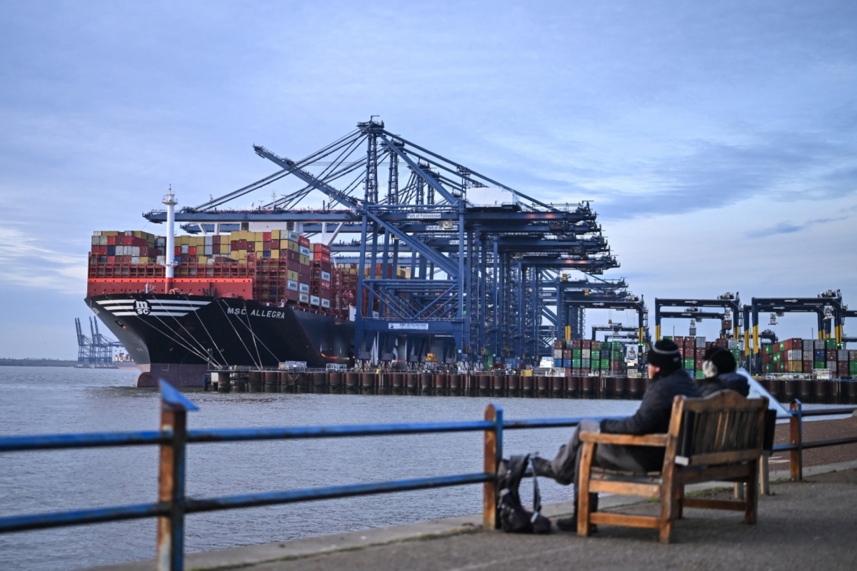 A container ship, docked beside container cranes at the UK's largest freight port, in Felixstowe on the East coast of England.