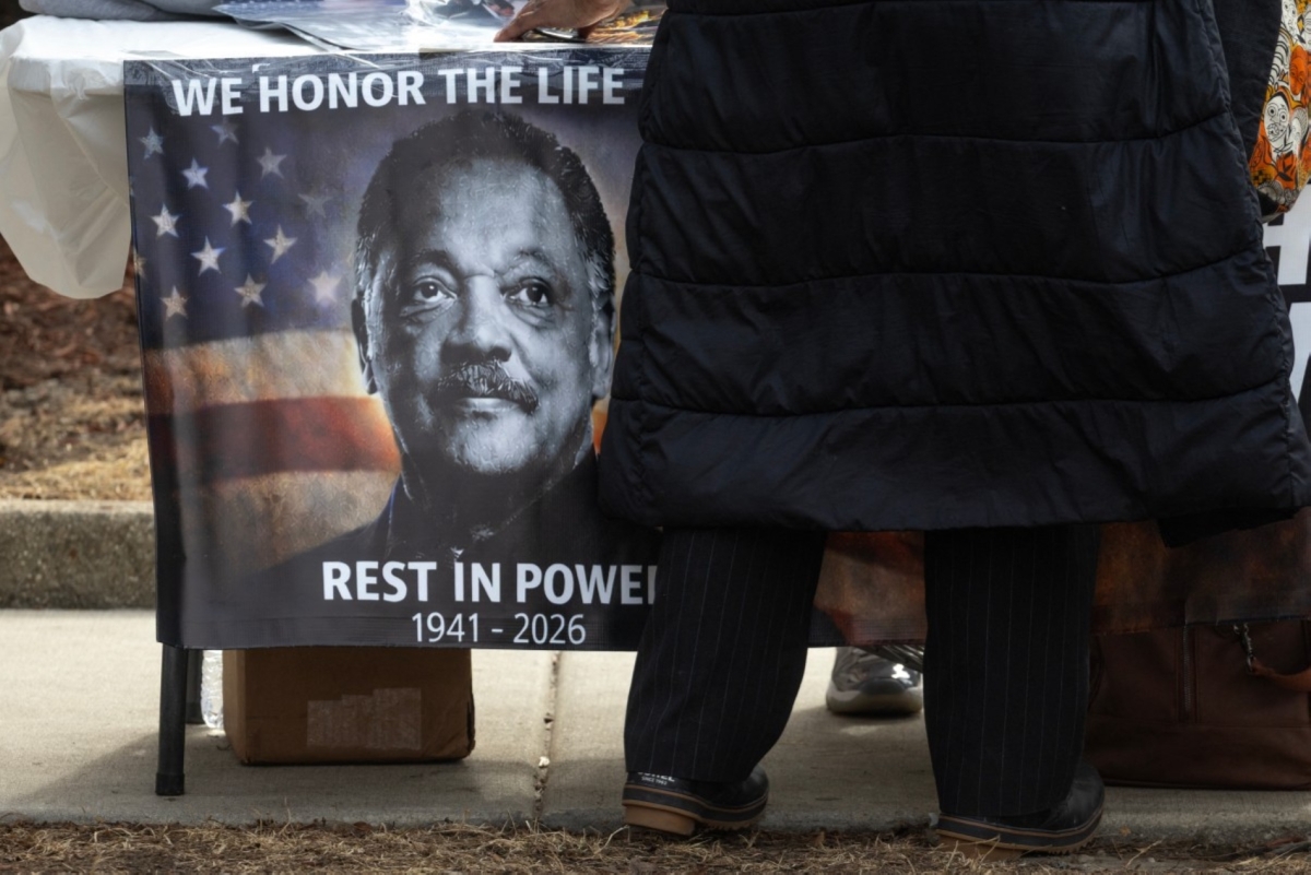 A vendor sells merchandise to people paying their respects to the late civil rights leader Rev. Jesse Jackson outside of the Rainbow PUSH Coalition national headquarters on 27 February 2026 in Chicago, Illinois.