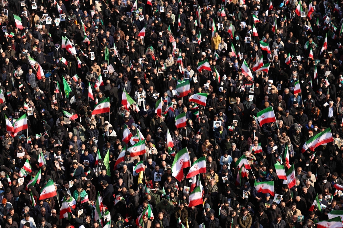 Demonstrators wave Iranian national flags as they gather for a rally in support of the new Supreme Leader at Enghelab Square in central Tehran on 9 March 2026.