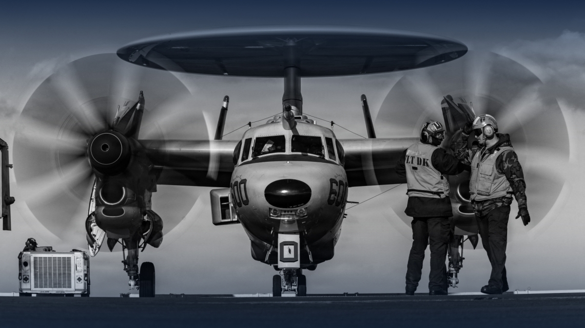US Navy sailors send signals to an E-2D Hawkeye aircraft, 124th Airborne Command and Control Squadron, as it walks on the deck of the aircraft carrier USS Gerald R. Ford, on 28 February 2026.
 