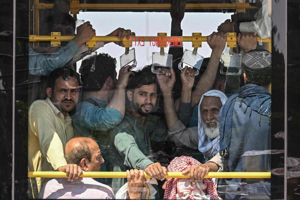 Commuters travel on a free state-run public bus in Islamabad on April 6, 2026, after the government drastically raised fuel prices due to the Iran war. 