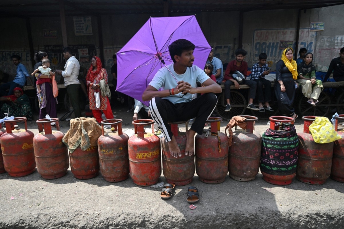 People wait to buy liquefied petroleum gas (LPG) cylinders at a gas agency office in Noida on 2 April 2026, amid ongoing oil and gas import disruptions caused by the Middle East war.