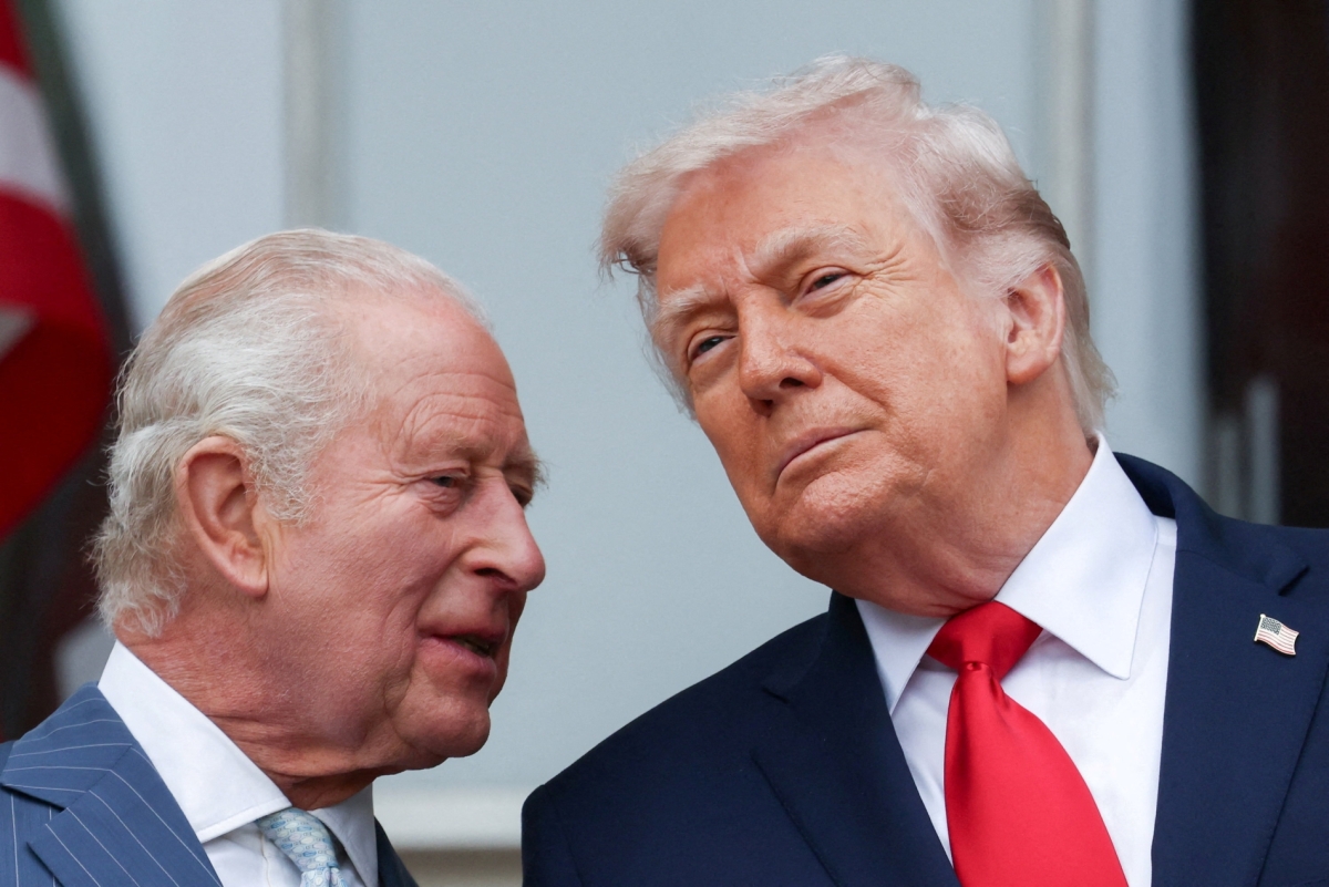 US President Donald Trump and Britain's King Charles talk as they watch a pass in review during an arrival ceremony for the king and Queen Camilla, at the White House in Washington, DC, on 28 April 2026. 