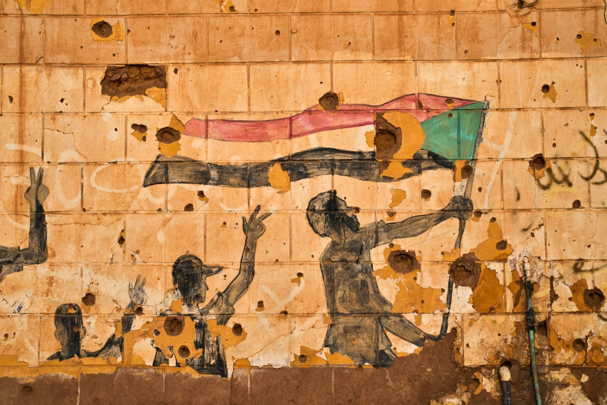 A painting depicting people holding the Sudanese flag is seen on a wall damaged by bullets and shrapnel in Omdurman, on the outskirts of Khartoum, Sudan, on 23 April 2026. 