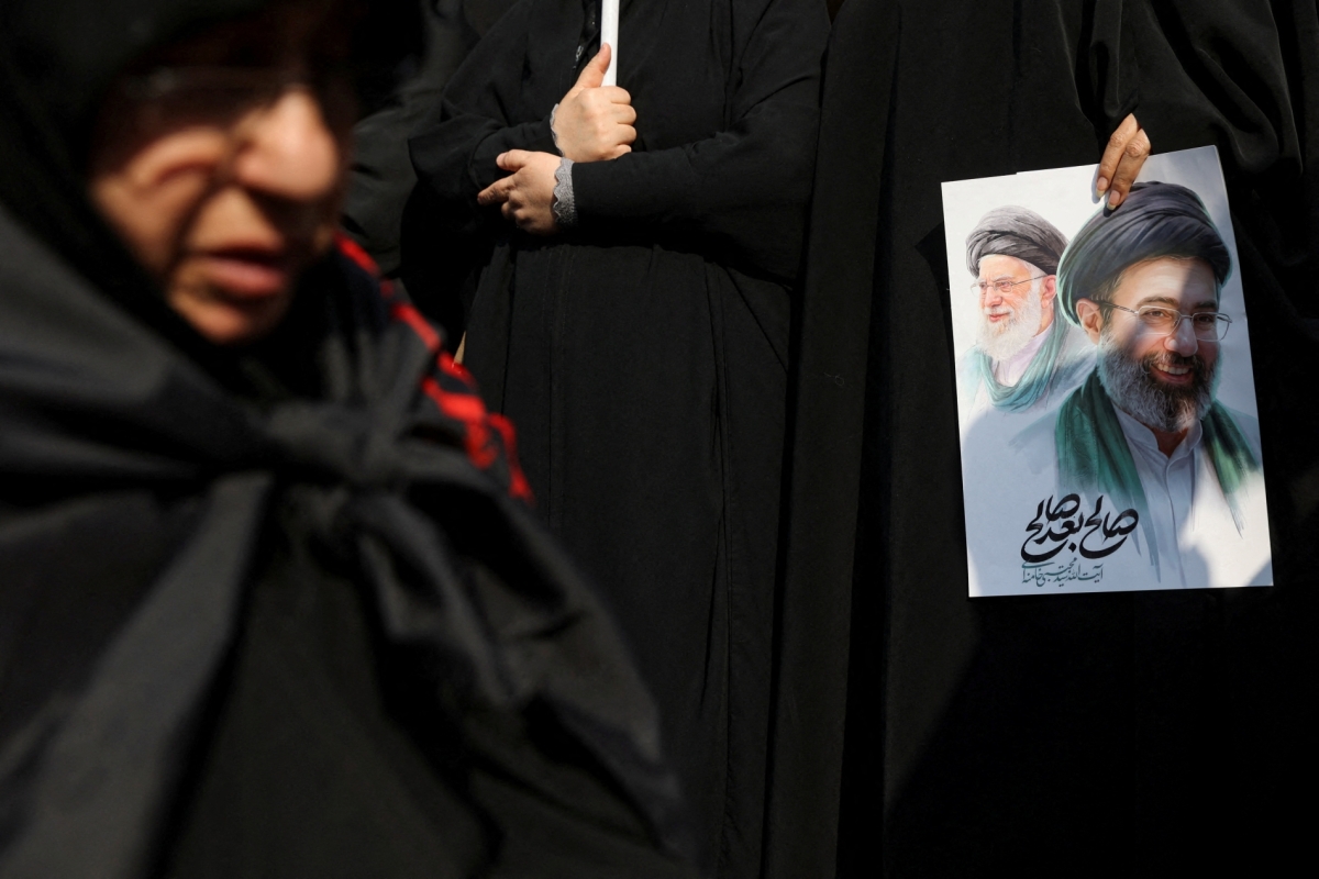 A woman holds an image of Iran's new supreme leader, Mojtaba Khamenei, alongside late Iranian Supreme Leader
Ayatollah Ali Khamenei. States have the resources, reach, and expertise to pursue their enemies.