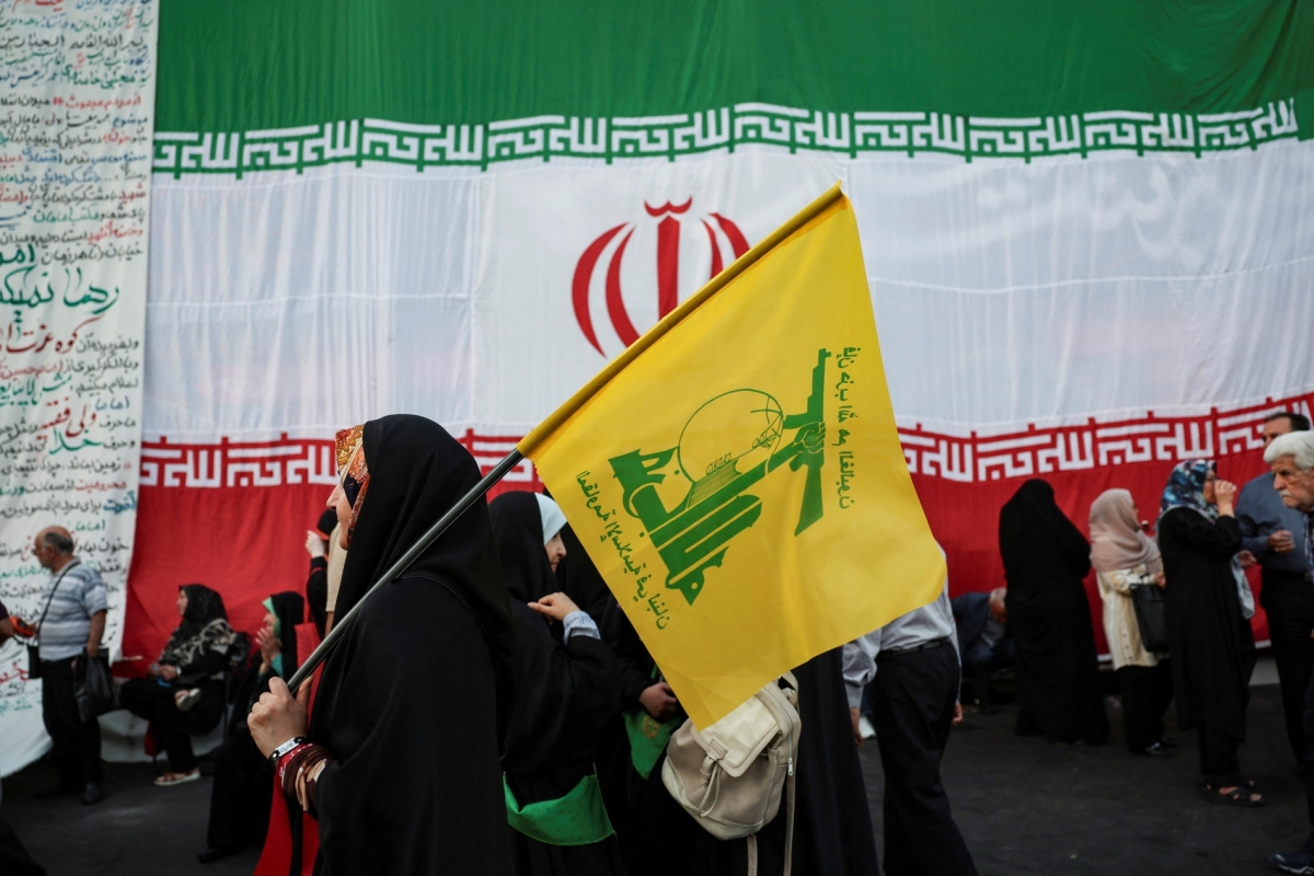 A woman holds a Hezbollah flag during a rally in support of Iran's Supreme Leader, Mojtaba Khamenei, in Tehran, Iran, on 4 June 2026. 