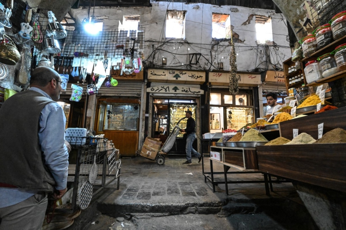LOUAI BESHARA / AFP
Photo by LOUAI BESHARA / AFP
A worker pushes a hand truck past a shop selling spices at the old market in Damascus ahead of the Eid al-Adha holiday on 26 May 2026.