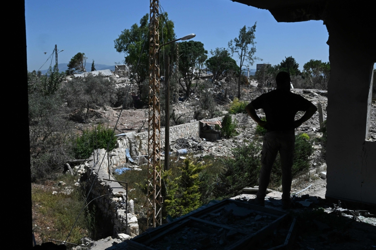 A man looks at the destruction from a damaged house as residents inspect their homes in Zawtar al-Gharbiya on 28 July 2026, after the Lebanese army deployed to the southern village.