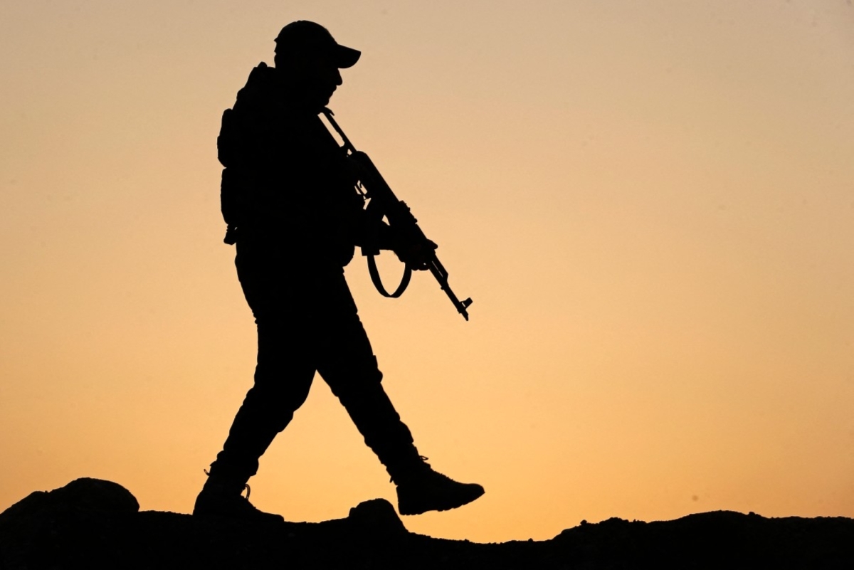 A member of the Popular Mobilisation Forces monitors the Iraq-Syria border in Al-Qaim, January 23, 2026.