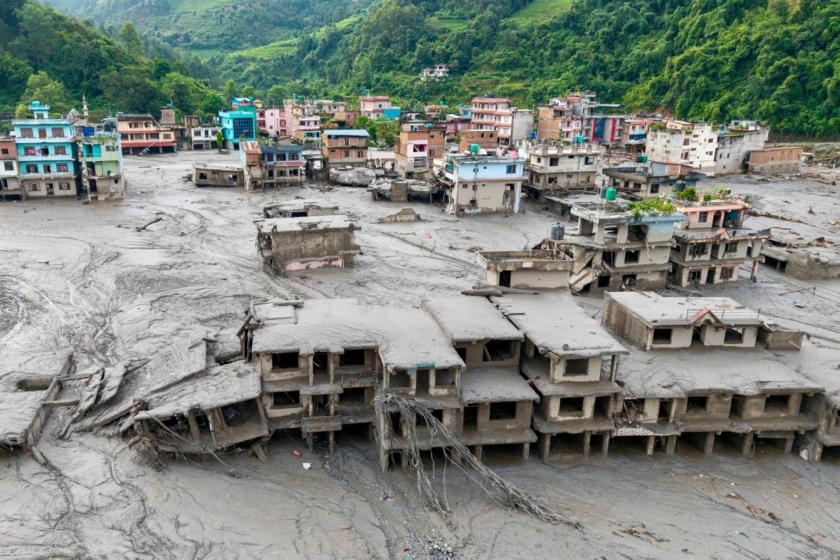 An aerial view shows houses lying deluged in sludge after flash floods in Devighat, Bidur Municipality, Nepal's Nuwakot district, on 27 August 2026.
