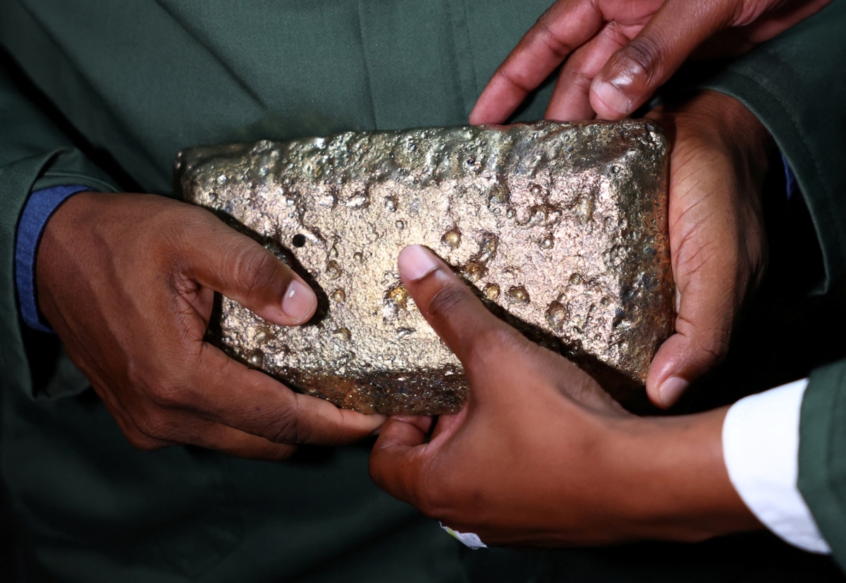 A person holds a raw gold bar inside Sibanye-Stillwater's Ezulwini processing plant, near Westonaria, west of South Africa, on 17 March 2026.
 
