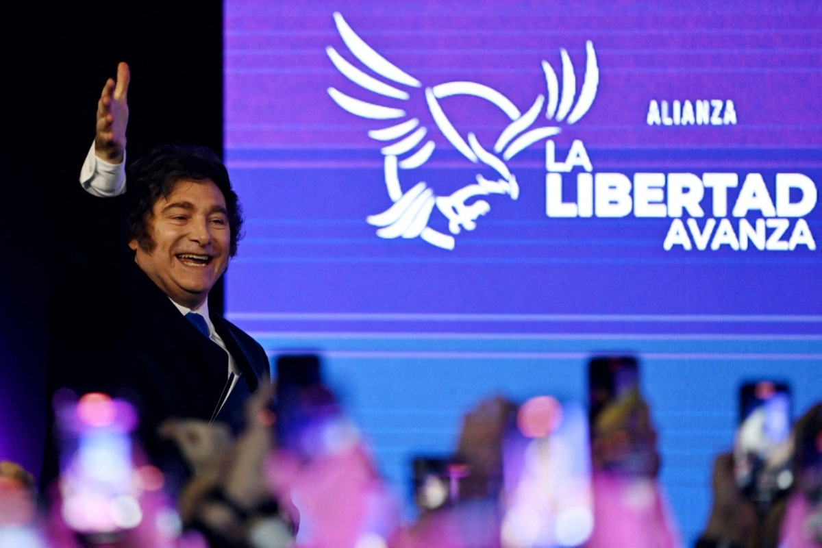 Argentina's President Javier Milei waves to supporters as he arrives at the ruling party's La Libertad Avanza headquarters following the results of the national midterm legislative election in Buenos Aires on 26 October 2025.