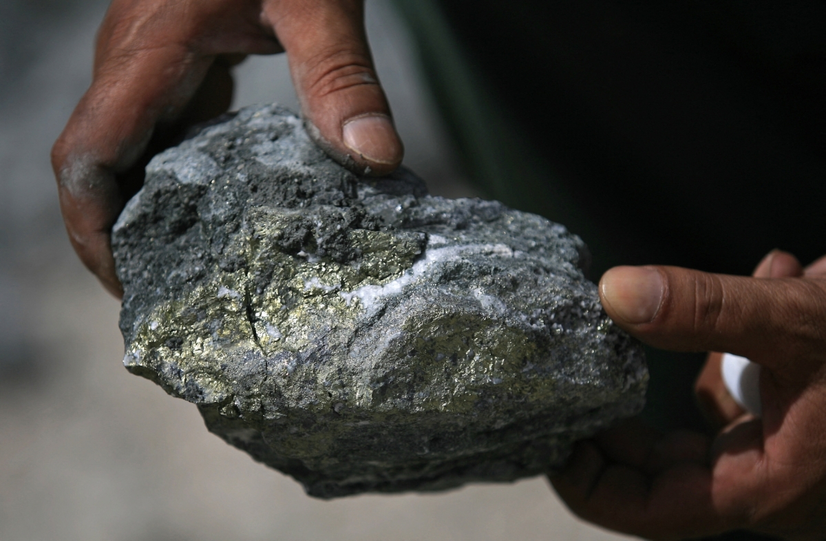 A person holds a piece of raw ore at the Al-Amar gold mine in Al-Quwayiyah, 195 kilometres southwest of the Saudi capital, Riyadh, on 28 May 2008.
 