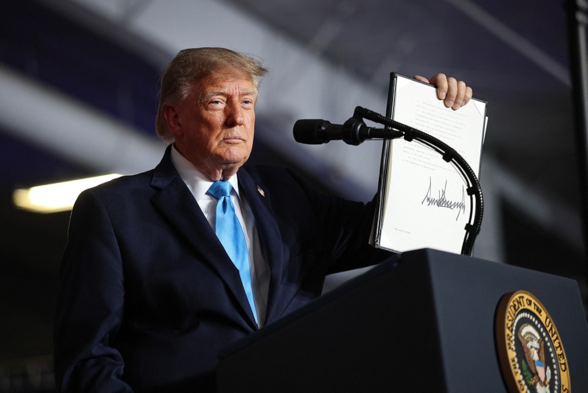US President Donald Trump signs an executive order to lower the cost of diesel fuel during a campaign rally at Pinnacle Bank Expo Centre on the Nebraska State Fairgrounds on 5 October 2026 in Grand Island, Nebraska.