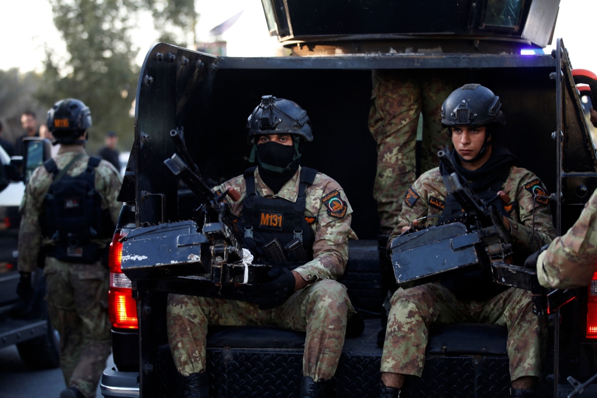 Members of Iraq's PMF keep guard on 8 February, 2024, during the funeral of Abu Baqr al-Saadi, a prominent leader in the Kataeb Hezbollah who was killed in an American drone strike on his car in Baghdad a day earlier.