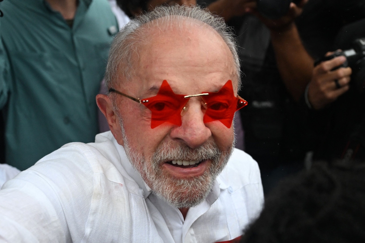 Brazil's President and Workers' Party (PT) re-election candidate Luiz Inácio Lula da Silva, greets supporters outside a polling station during the presidential runoff election in Sao Paulo on 25 October 2026.