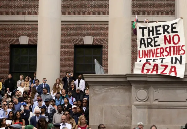  A protester holds a sign reading "There are no universities left in Gaza" amid the commencement ceremony on May 29, 2025, in Cambridge, Massachusetts.