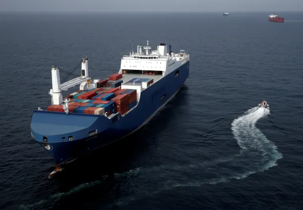 A French patrol boat sails next to the Bahri-Yanbu, a Saudi Arabian cargo ship, that waits to enter the French port of Le Havre on 10 May 2019. 