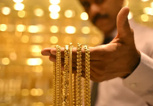A salesman displays gold chains, at Jos Alukkas jewellery store in Bengaluru on 17 September 2025. 