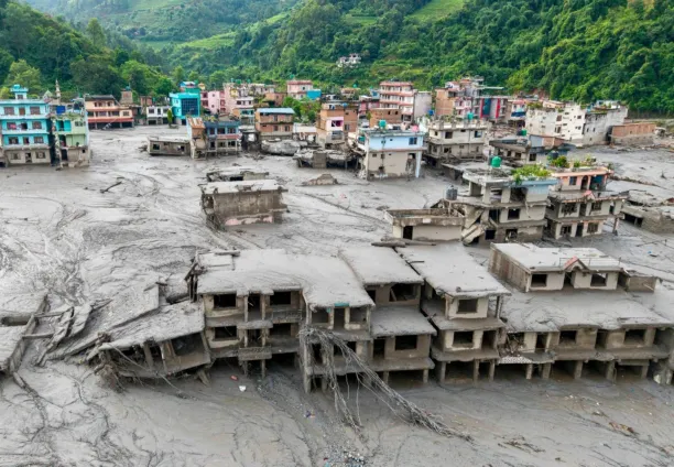 An aerial view shows houses lying deluged in sludge after flash floods in Devighat, Bidur Municipality, Nepal's Nuwakot district, on 27 August 2026.
