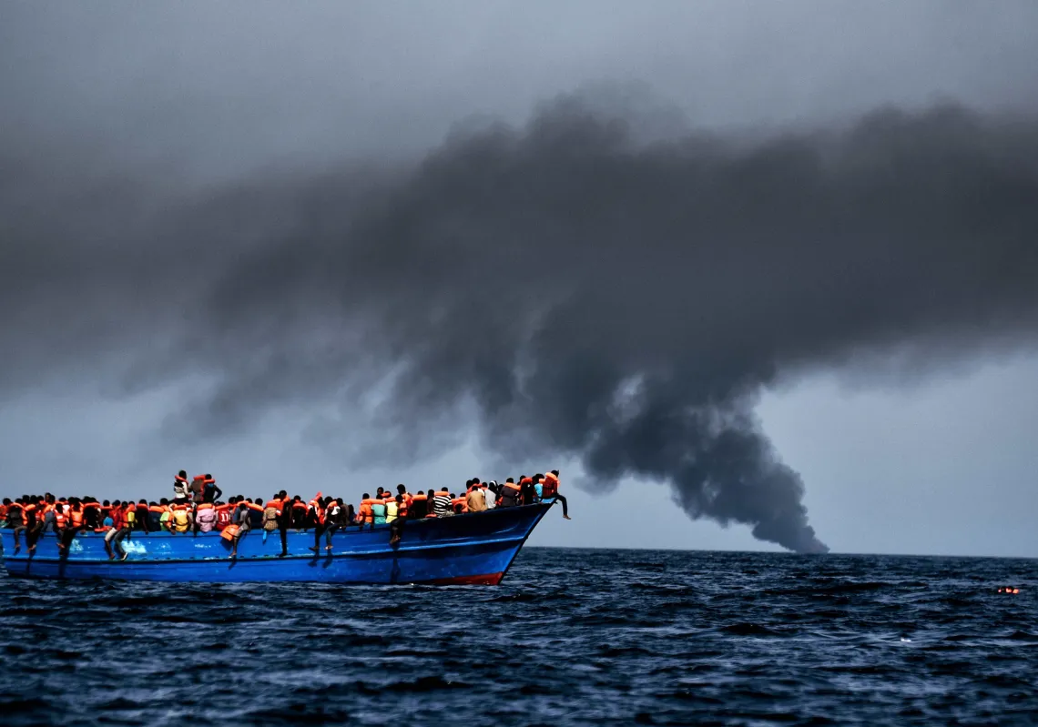 Migrants wait to be rescued as they drift at sunset in the Mediterranean Sea some 20 nautical miles north off the coast of Libya on October 3, 2016. (Getty)